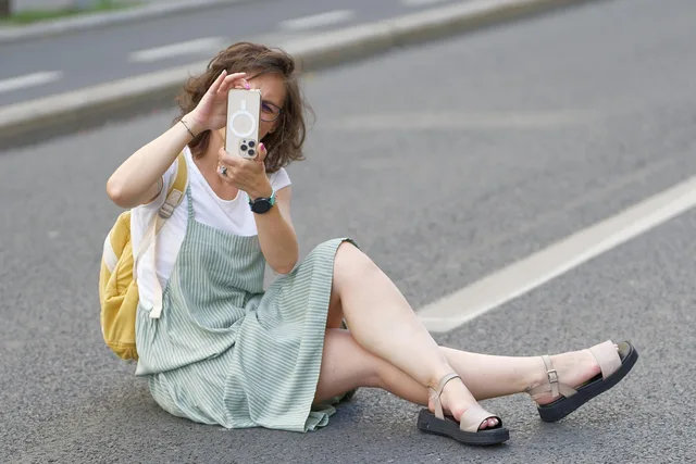 woman, young, casual, glasses, backpack, smartphone, sitting, street, urban, lifestyle. Common Gen Z content marketing questions, answered