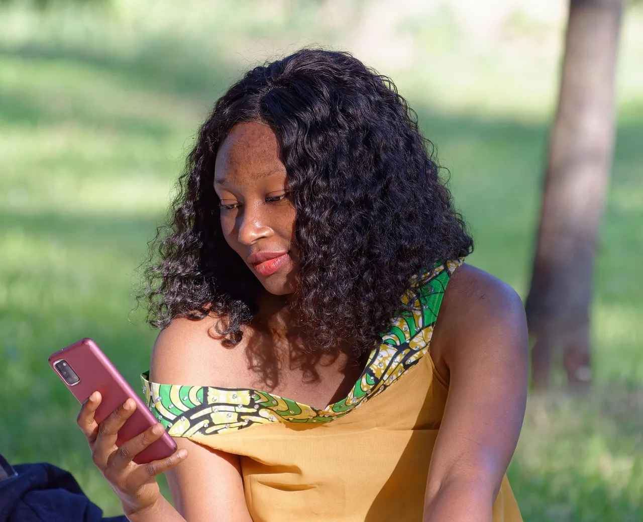 woman, young, african, looking, smartphone, sitting, outdoors, naturally, parka. Review, claim and data checks for Gen Z brand loyalty research methods