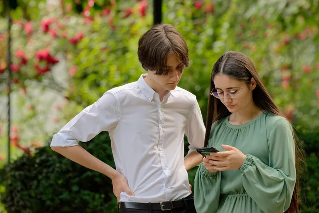 people, young, coup, girlie, boy, looking, together, smartphone, outdoors, naturally, parka. How to vet Gen Z content marketing benchmarks