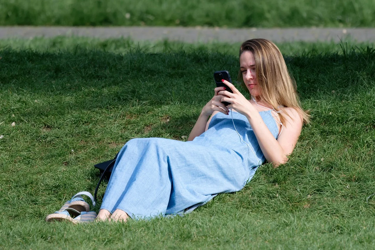 woman, smartphone, park, young, relaxing, grass, nature, lifestyle. Where to find and vet Gen Z marketing strategy case studies