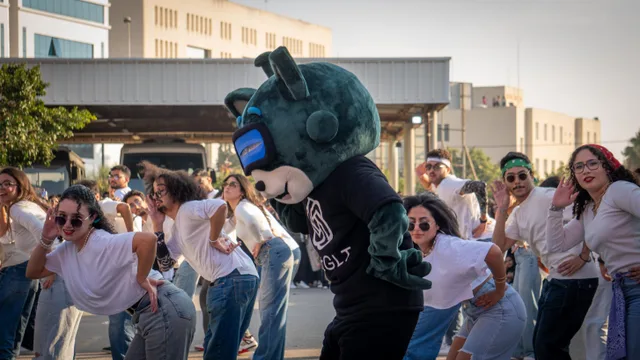 Street dance group performing with a large mascot costume in an outdoor urban setting. Gen z social media examples that teach more than the theory